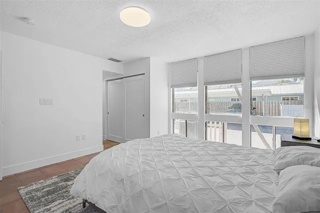 a bedroom with a bed and glass window