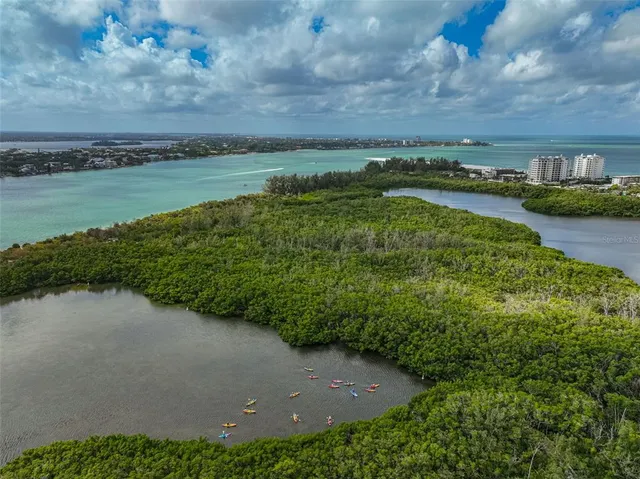 an aerial view of a house with balcony and furniture