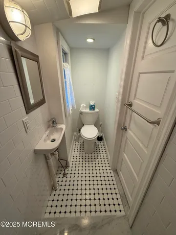 a bathroom with a sink a toilet a shower a vanity and a mirror