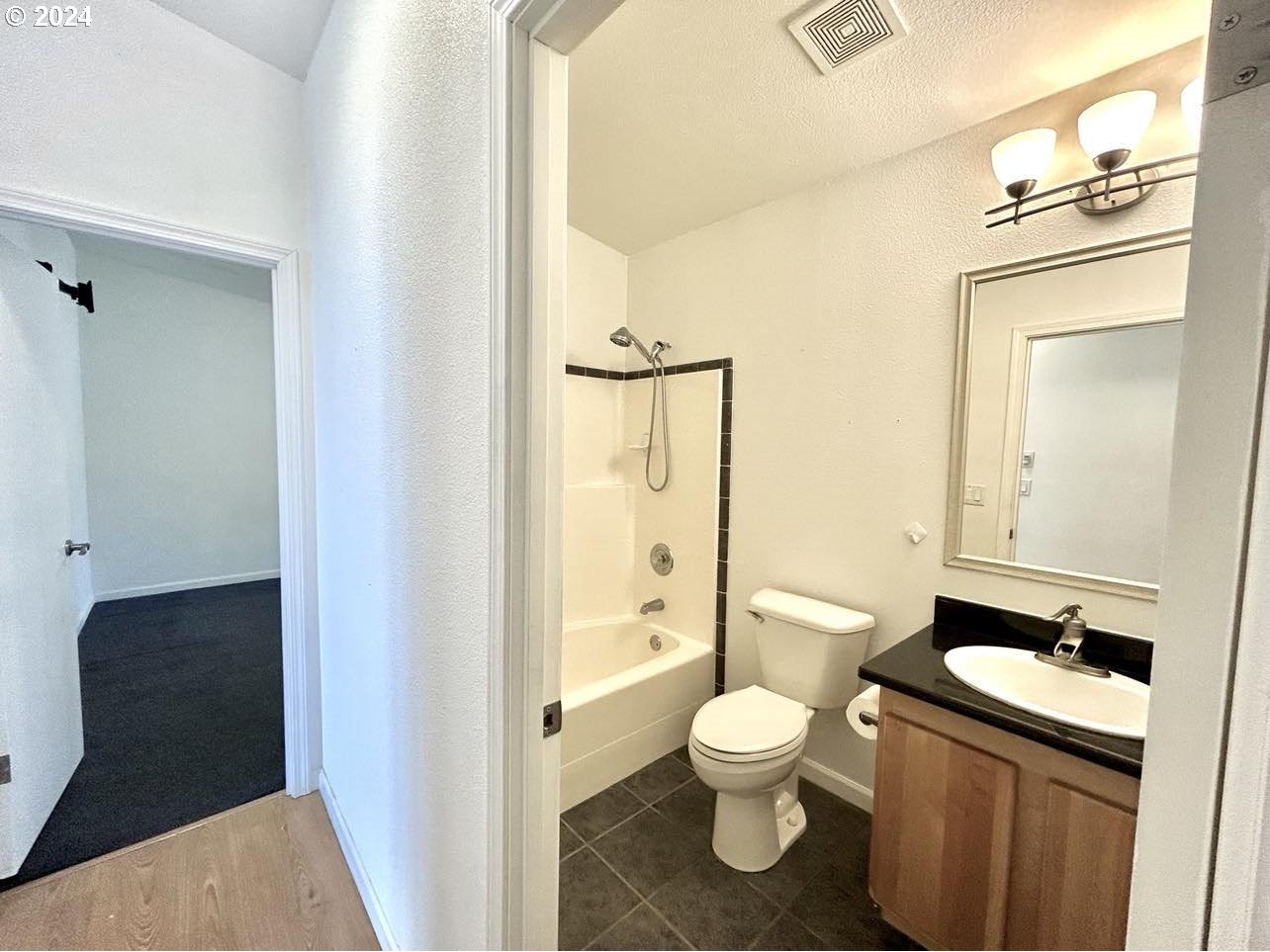 30190 South Oswalt Road Colton, OR 97017 - Photo 13 of 33 a bathroom with a granite countertop toilet a sink and a mirror