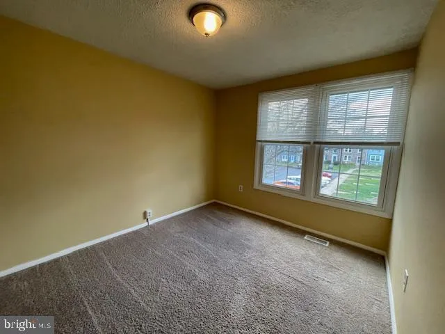 a view of hallway with stairs and wooden floor