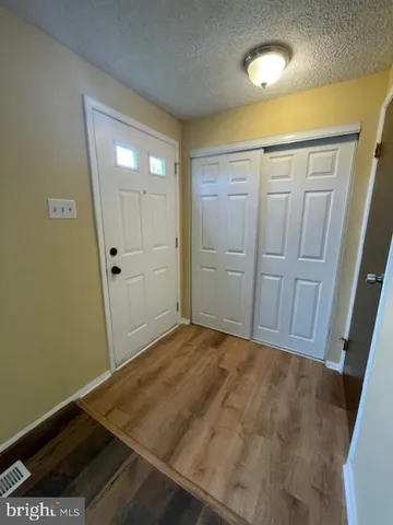 an empty room with wooden floor