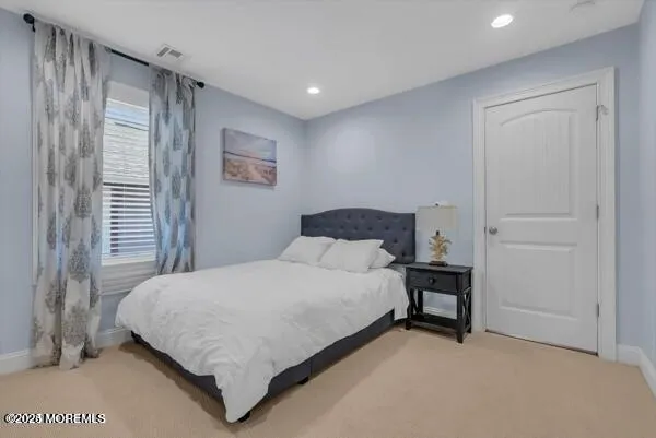 a bedroom with a bed and a table