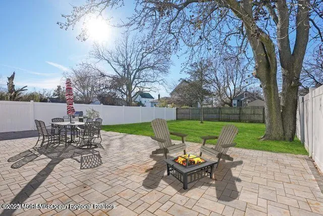 a view of a patio with chairs and table