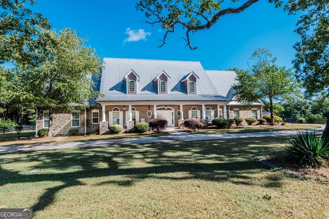 a front view of a house with a garden
