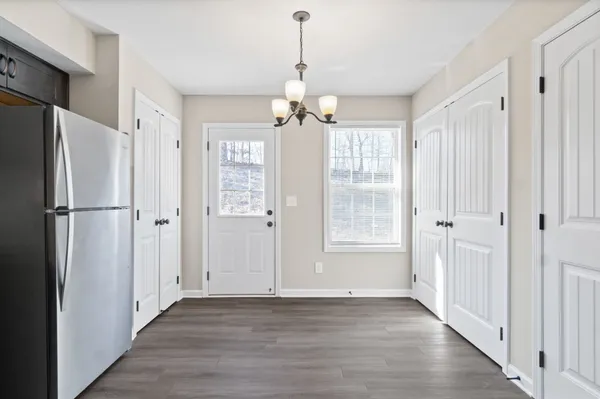 a view of kitchen with granite countertop cabinets and stainless steel appliances