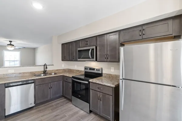 a kitchen with a refrigerator stove and sink