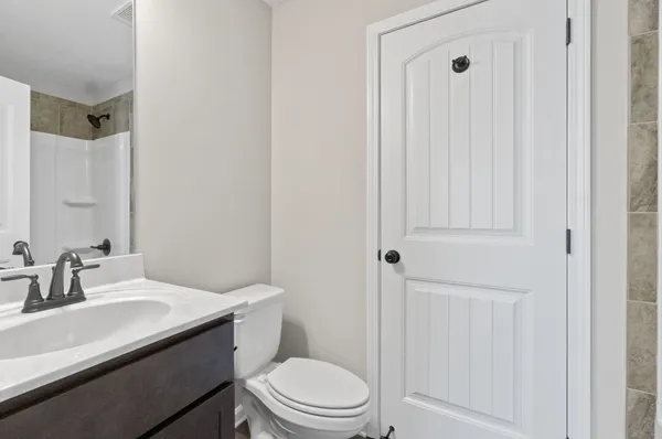 an empty room with window and ceiling fan