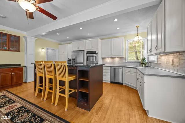 a kitchen with stainless steel appliances granite countertop a sink and cabinets