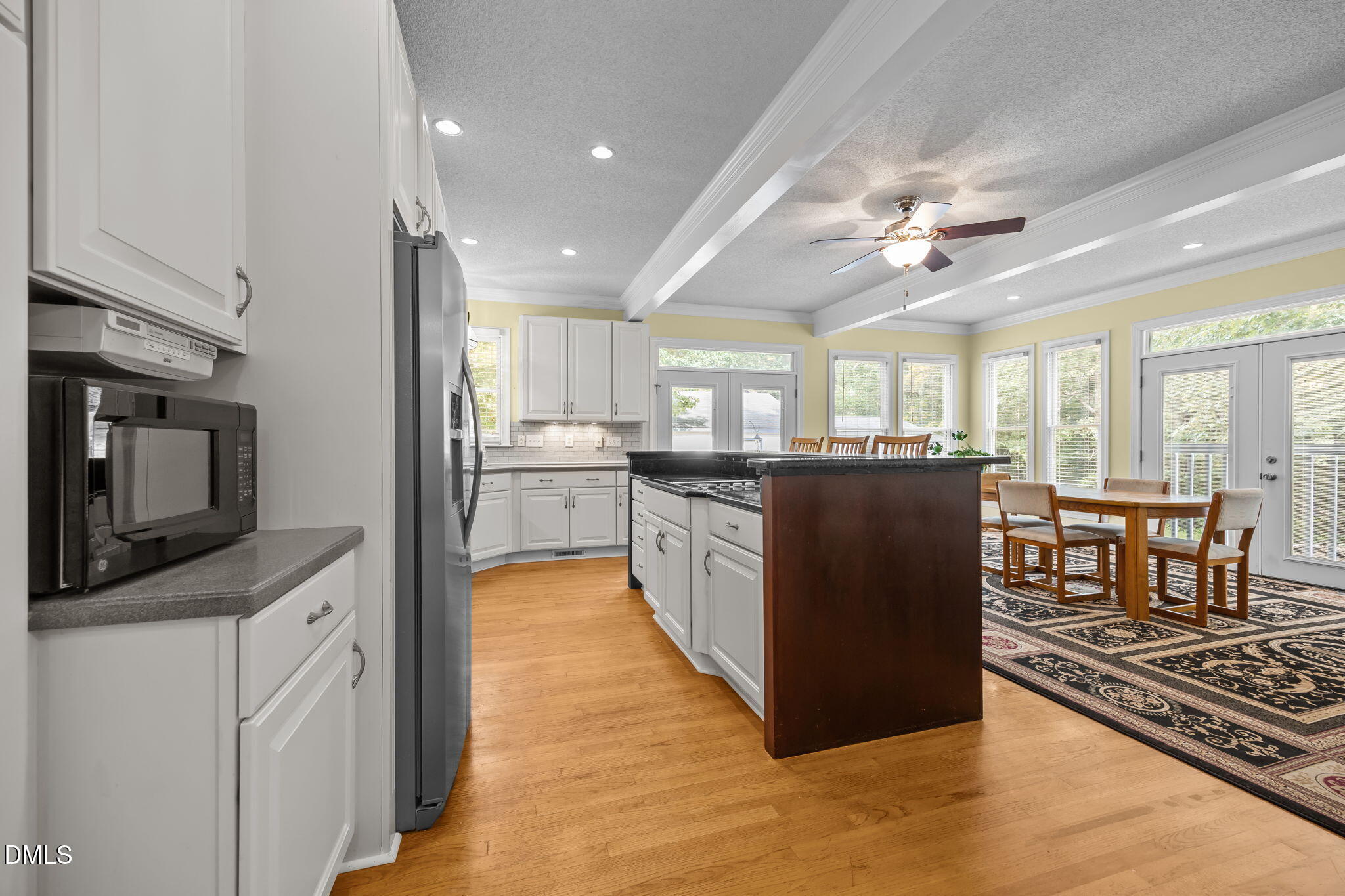 8641 Buffaloe Road Knightdale, NC 27545 - Photo 10 of 52 a kitchen with stainless steel appliances granite countertop a refrigerator a stove top oven a sink dishwasher and dining table with wooden floor