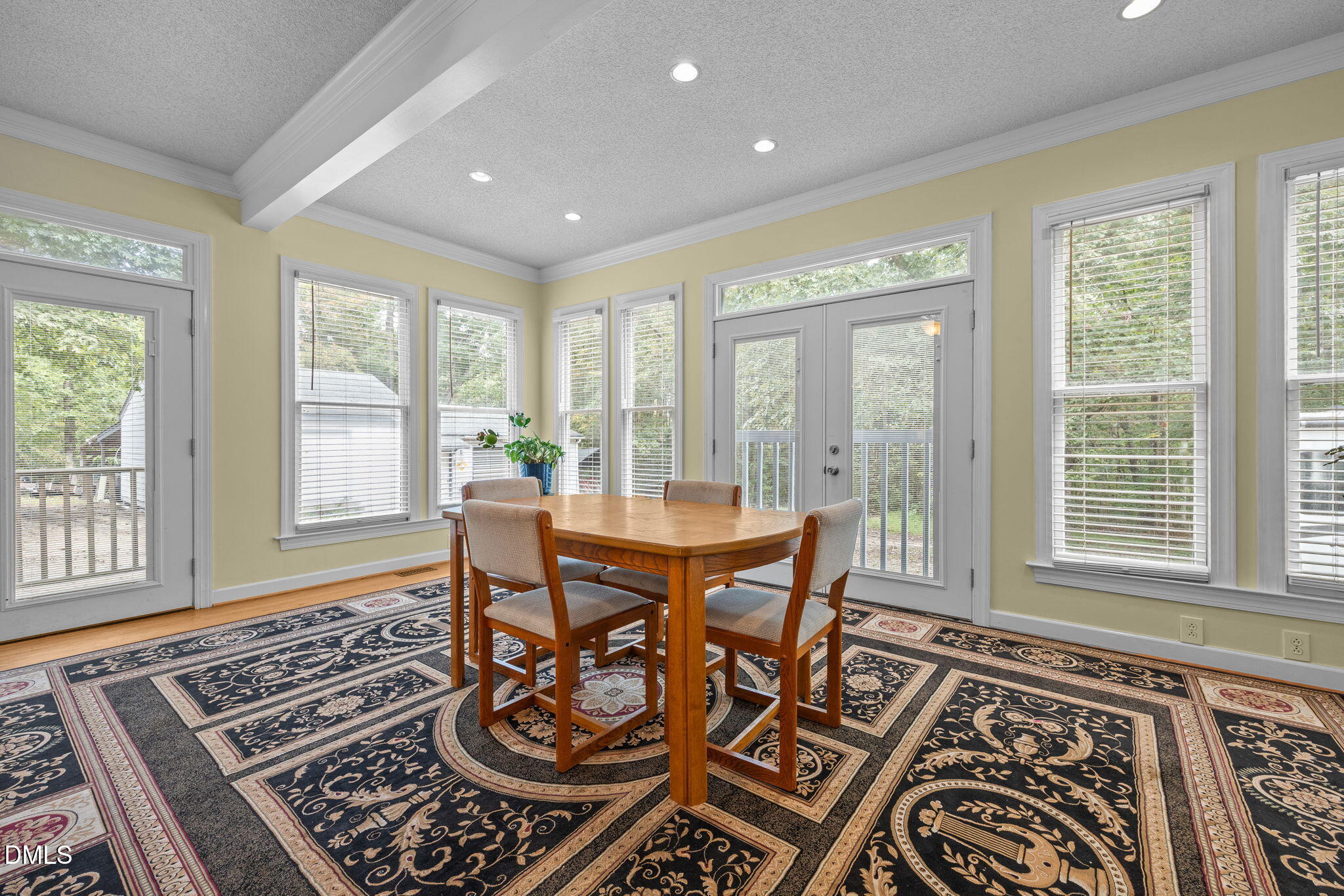 8641 Buffaloe Road Knightdale, NC 27545 - Photo 13 of 52 a view of a dining room with furniture wooden floor and a rug