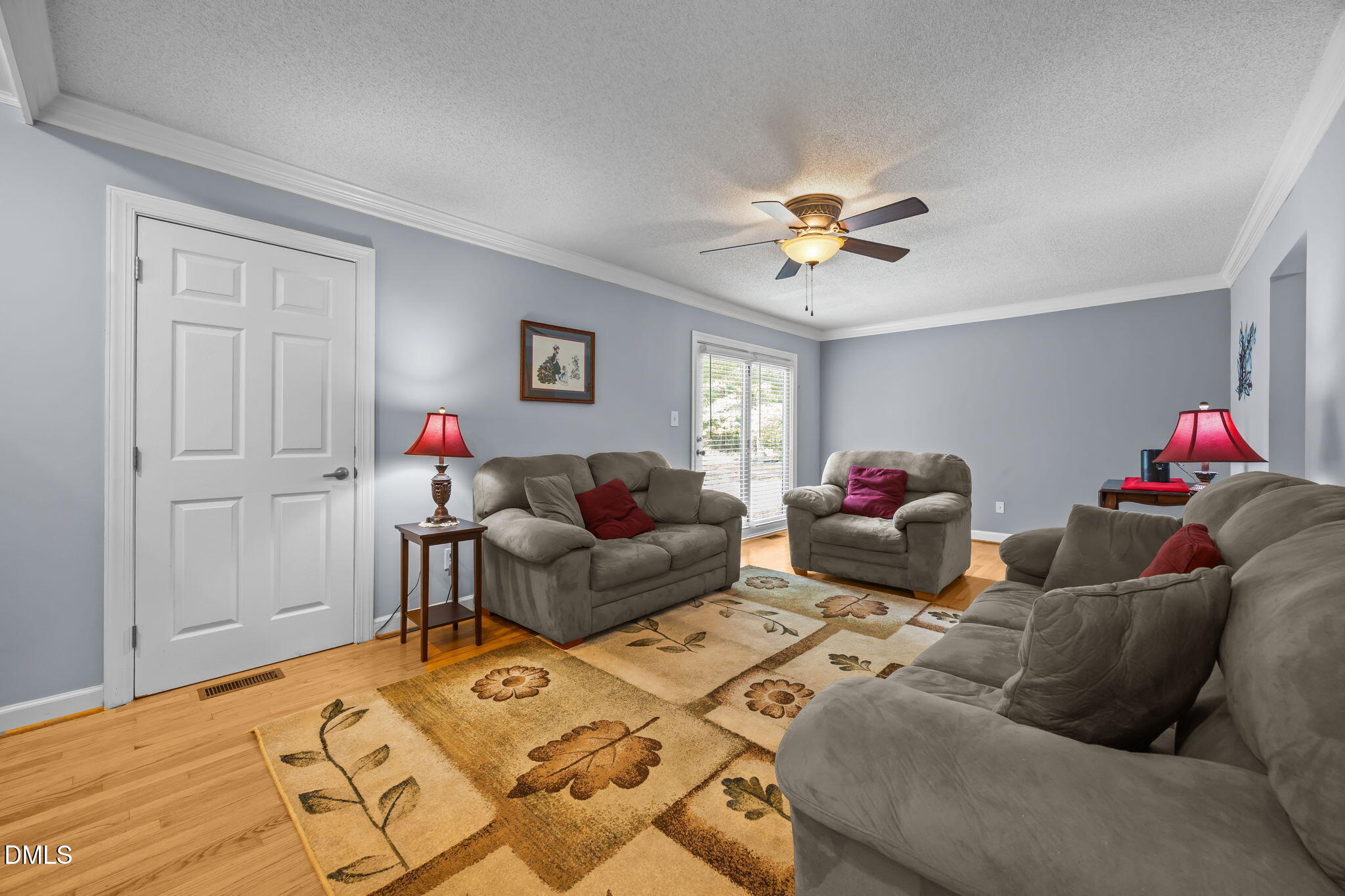 8641 Buffaloe Road Knightdale, NC 27545 - Photo 15 of 52 a living room with furniture and a chandelier