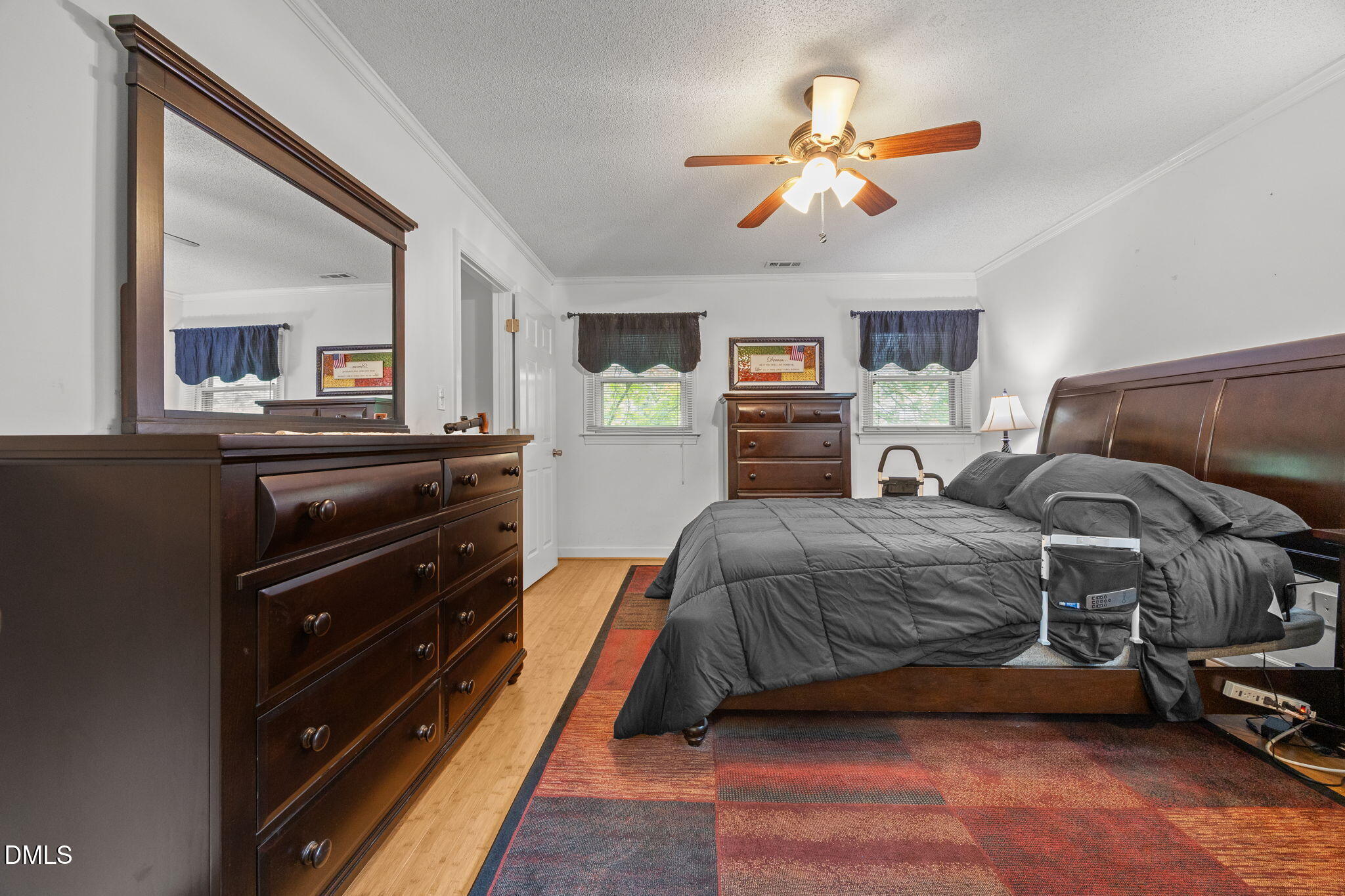 8641 Buffaloe Road Knightdale, NC 27545 - Photo 24 of 52 a bedroom with a bed and a chandelier