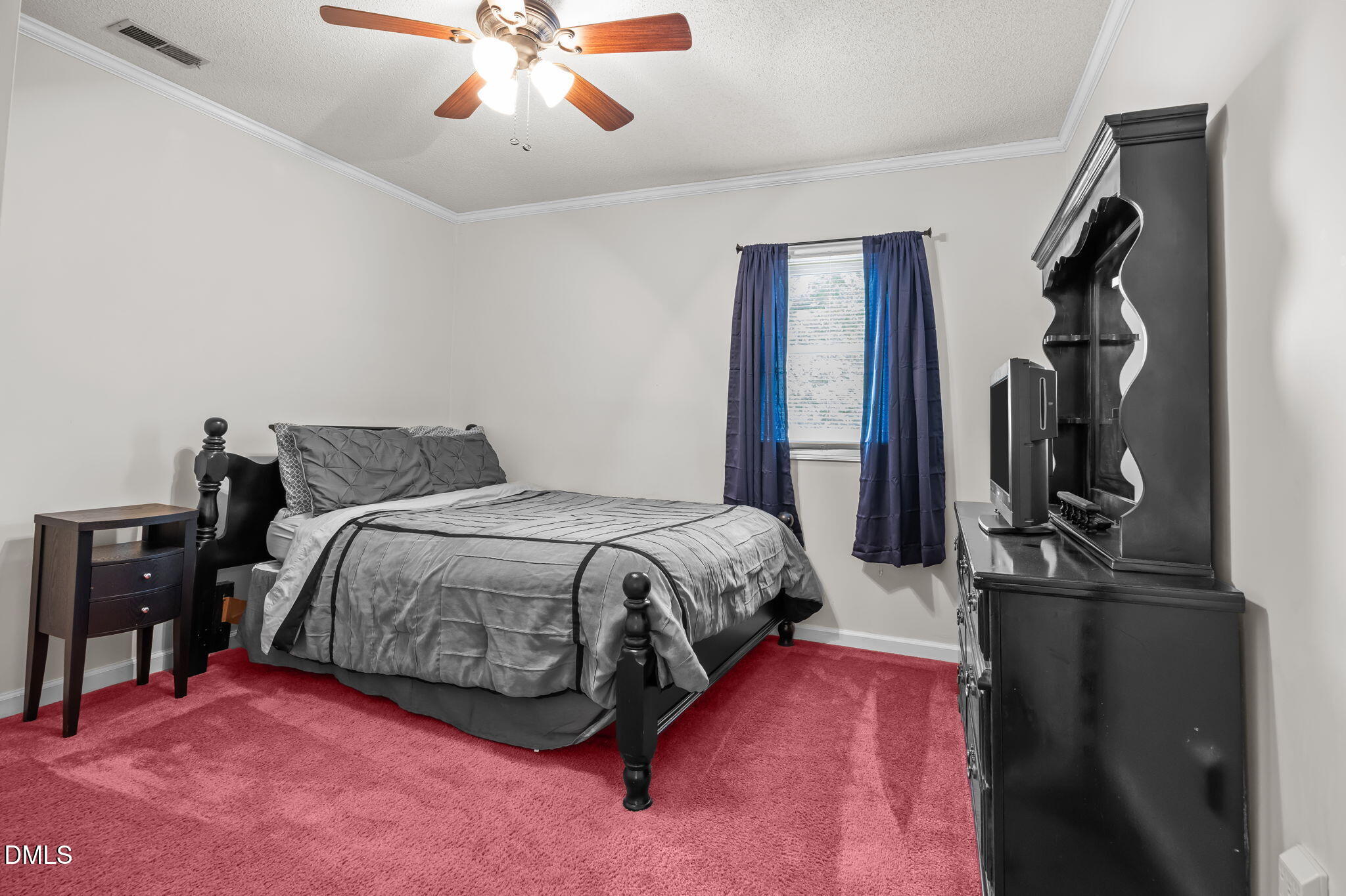 8641 Buffaloe Road Knightdale, NC 27545 - Photo 27 of 52 a spacious bedroom with a bed and a chandelier