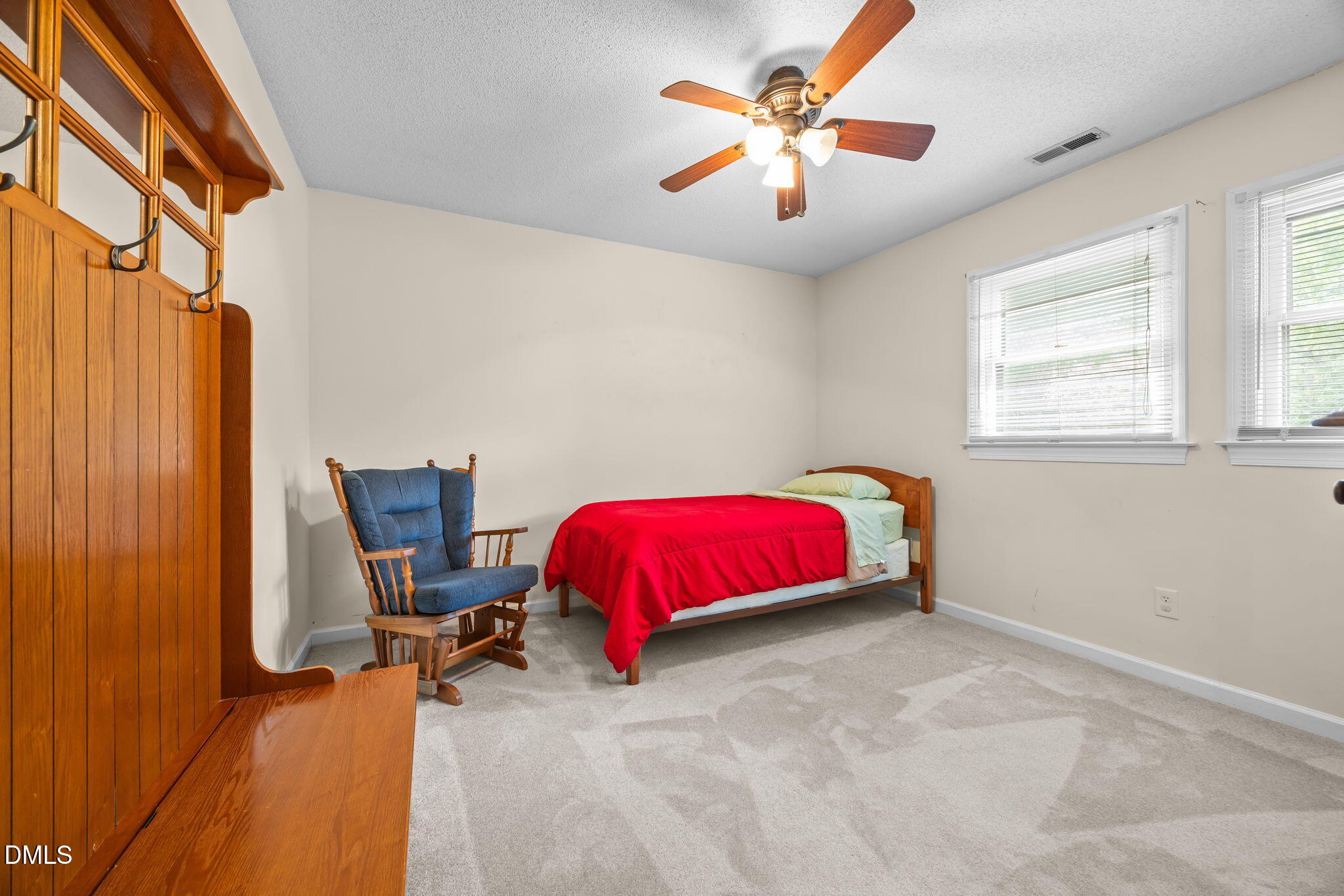 8641 Buffaloe Road Knightdale, NC 27545 - Photo 29 of 52 a bedroom with a bed and a chandelier