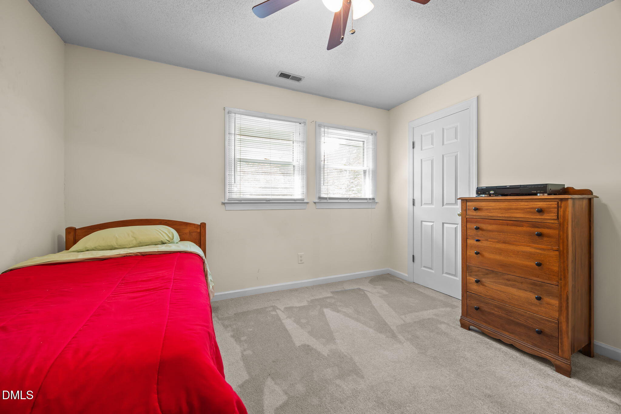 8641 Buffaloe Road Knightdale, NC 27545 - Photo 30 of 52 a view of a bedroom with a bed and a ceiling fan