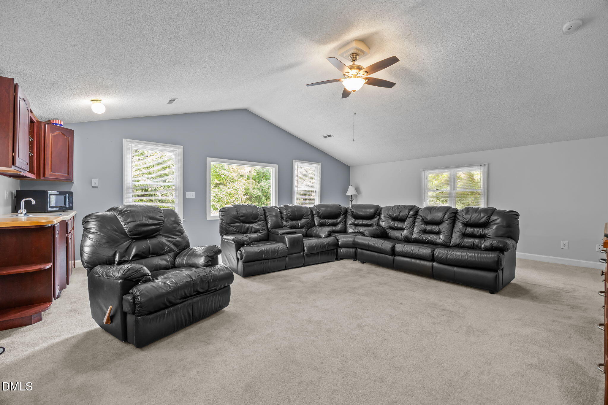 8641 Buffaloe Road Knightdale, NC 27545 - Photo 32 of 52 a living room with furniture and a chandelier