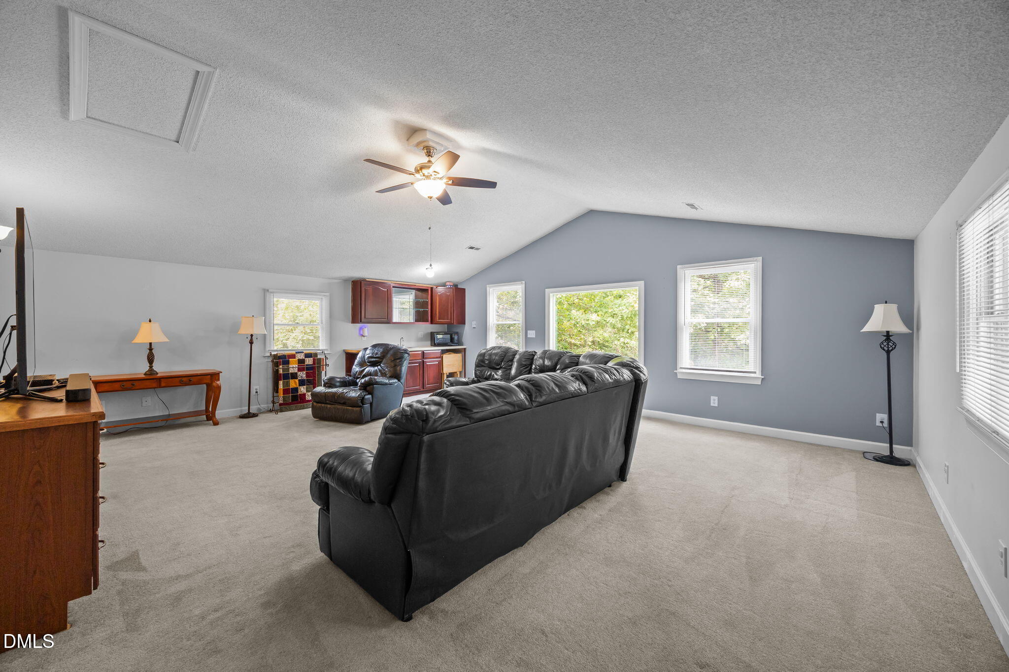 8641 Buffaloe Road Knightdale, NC 27545 - Photo 33 of 52 a living room with furniture a ceiling fan and a window