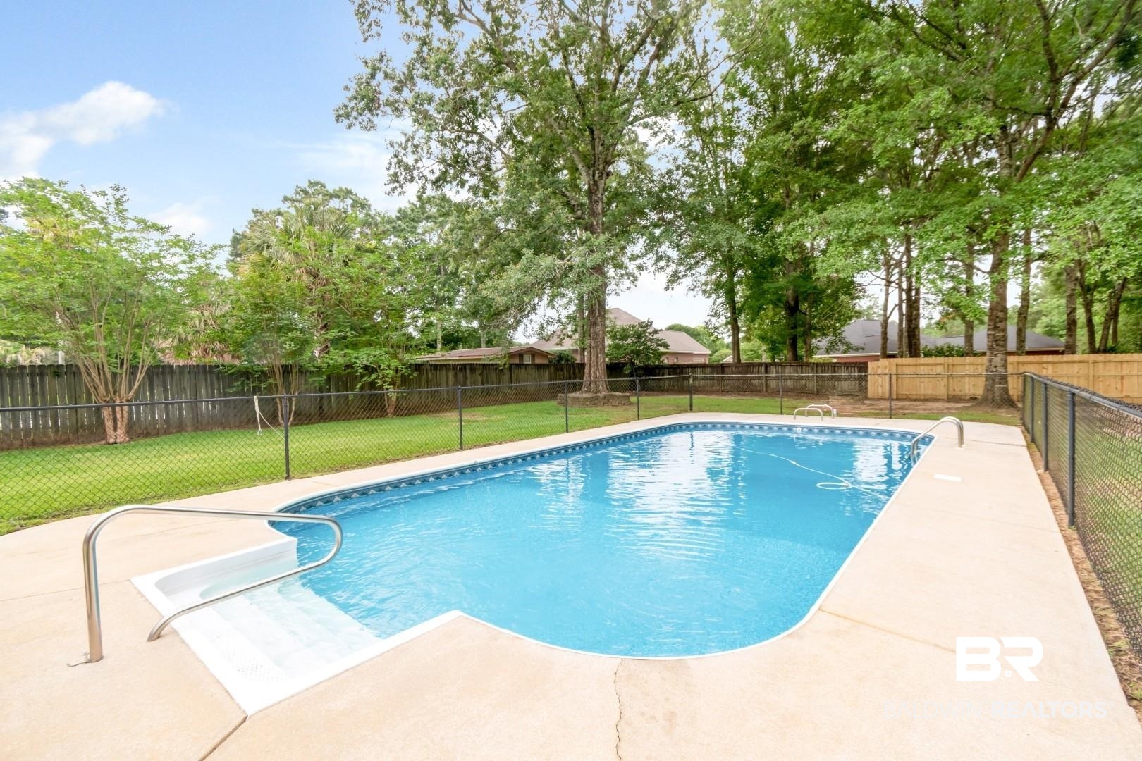 10691 Hunters Ridge Drive Mobile, AL 36695 - Photo 29 of 37 Rectangular swimming pool with integrated steps, surrounded by a concrete patio
