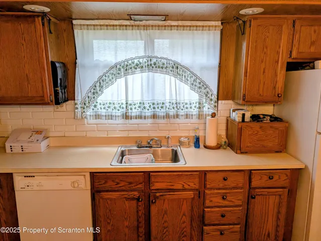 a kitchen with a sink appliances and cabinets