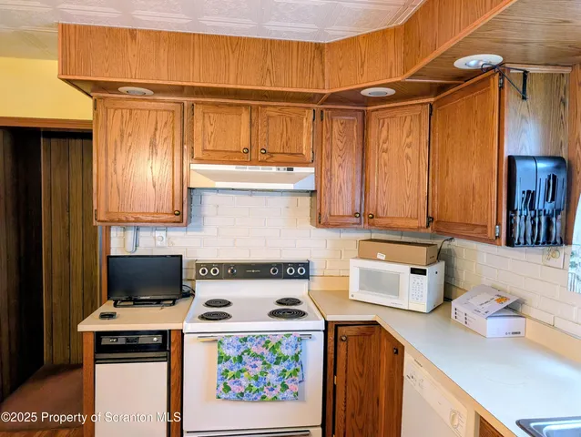 a living room with a couch a rug and a chandelier