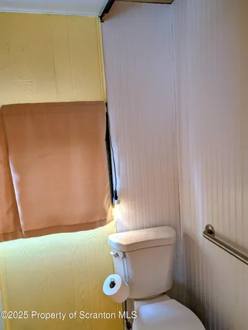 a bathroom with a sink a toilet and a shower curtain