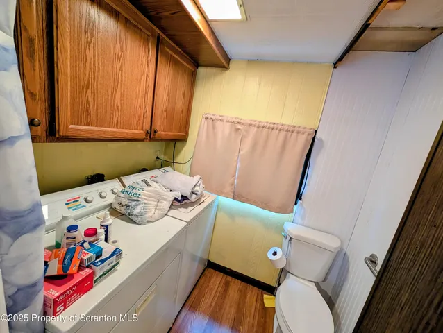 a room with lots of wooden furniture and windows