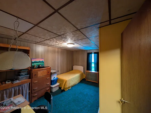 a bedroom with furniture and a window