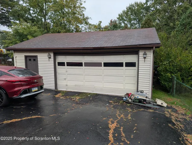 a view of a house with pool and chairs