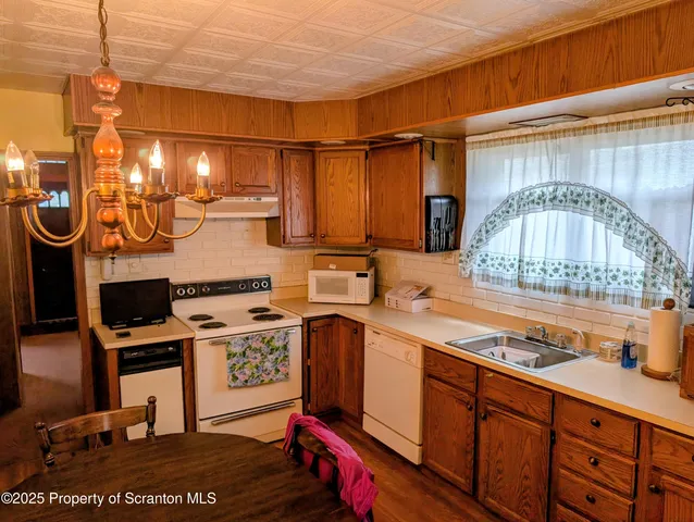a kitchen with a sink and a mirror