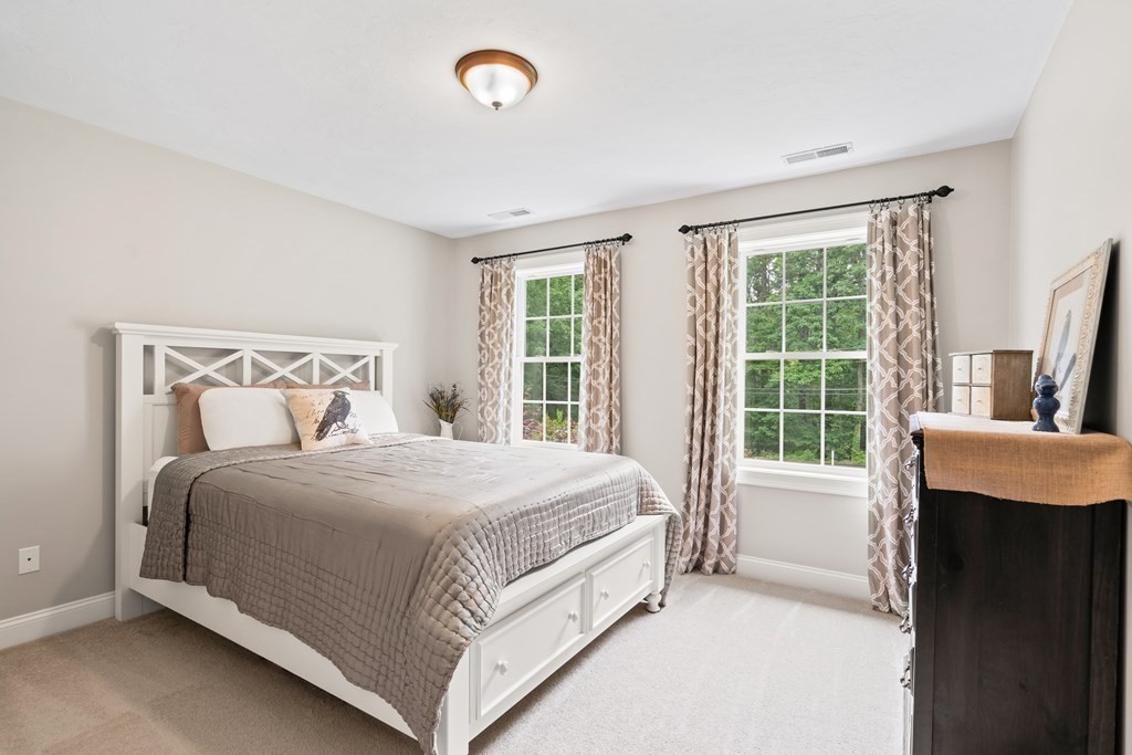 22 Randall Road Stow, MA 01775 - Photo 22 of 38 a bed sitting in a bedroom next to a window