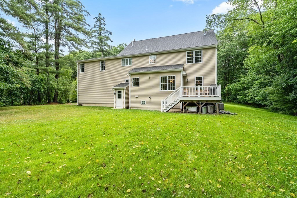 22 Randall Road Stow, MA 01775 - Photo 34 of 38 a white house that has a big yard with wooden fence