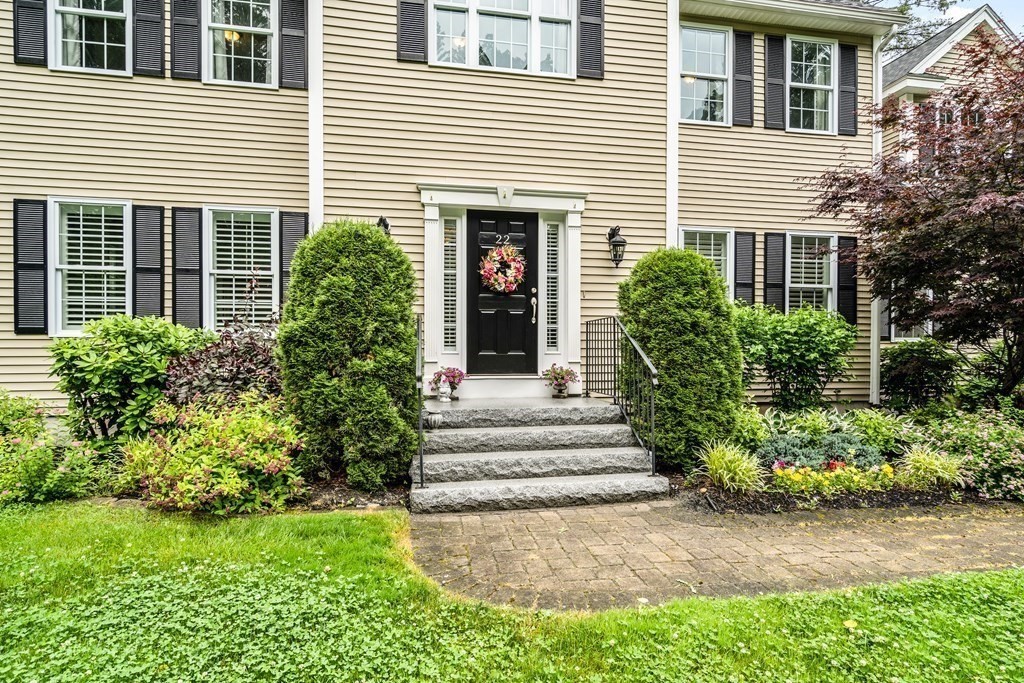22 Randall Road Stow, MA 01775 - Photo 5 of 38 a view of a house with potted plants and a small yard