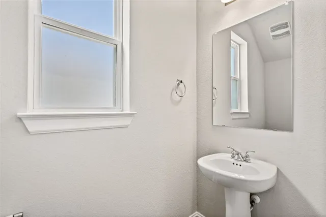 a view of kitchen with microwave and refrigerator