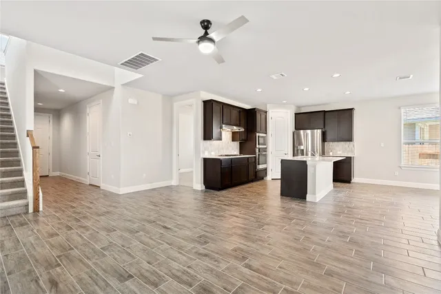 a large kitchen with a large counter top appliances and cabinets