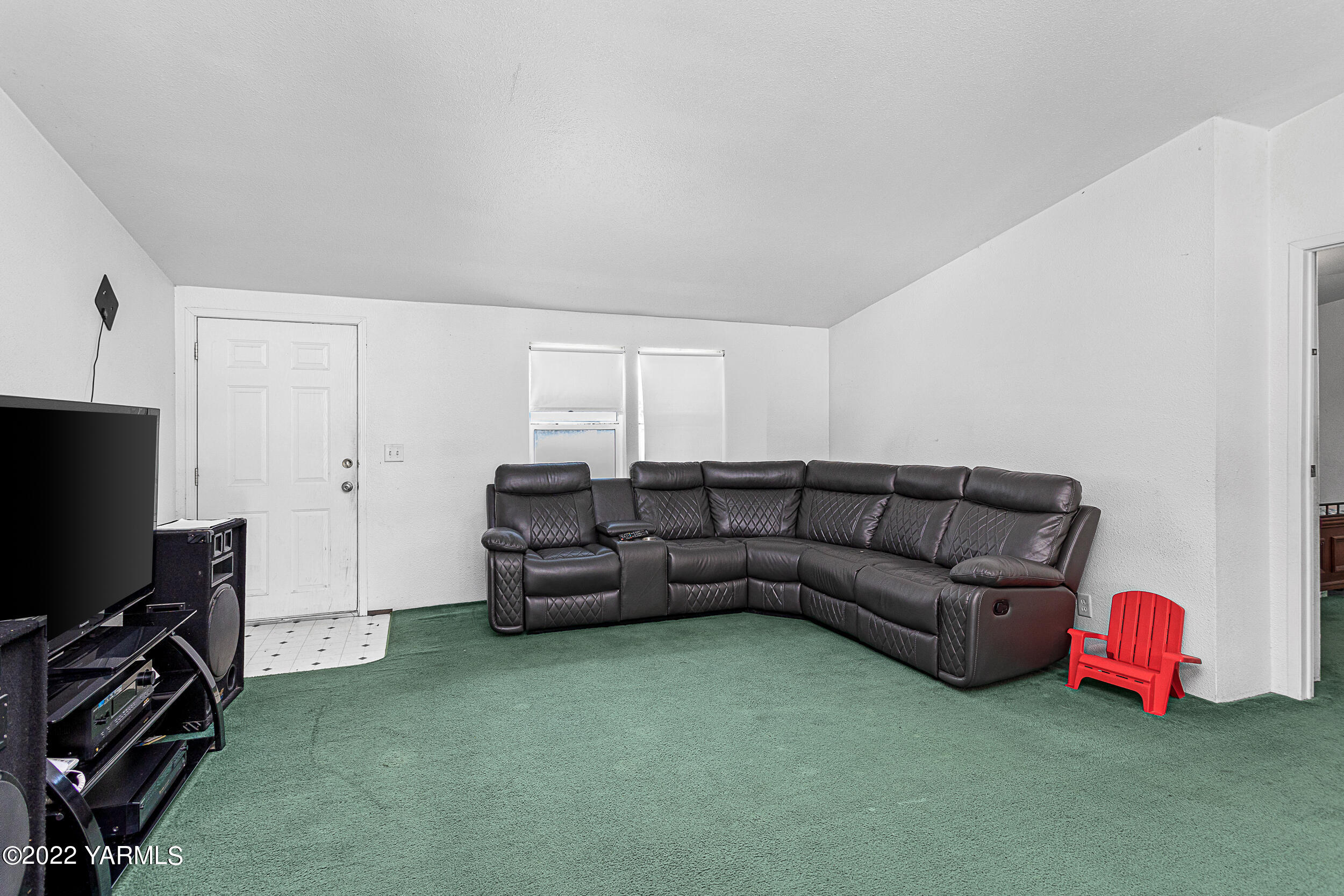 221 Rowberry Way Toppenish, WA 98948 - Photo 15 of 31 a living room with furniture a flat screen tv and a window