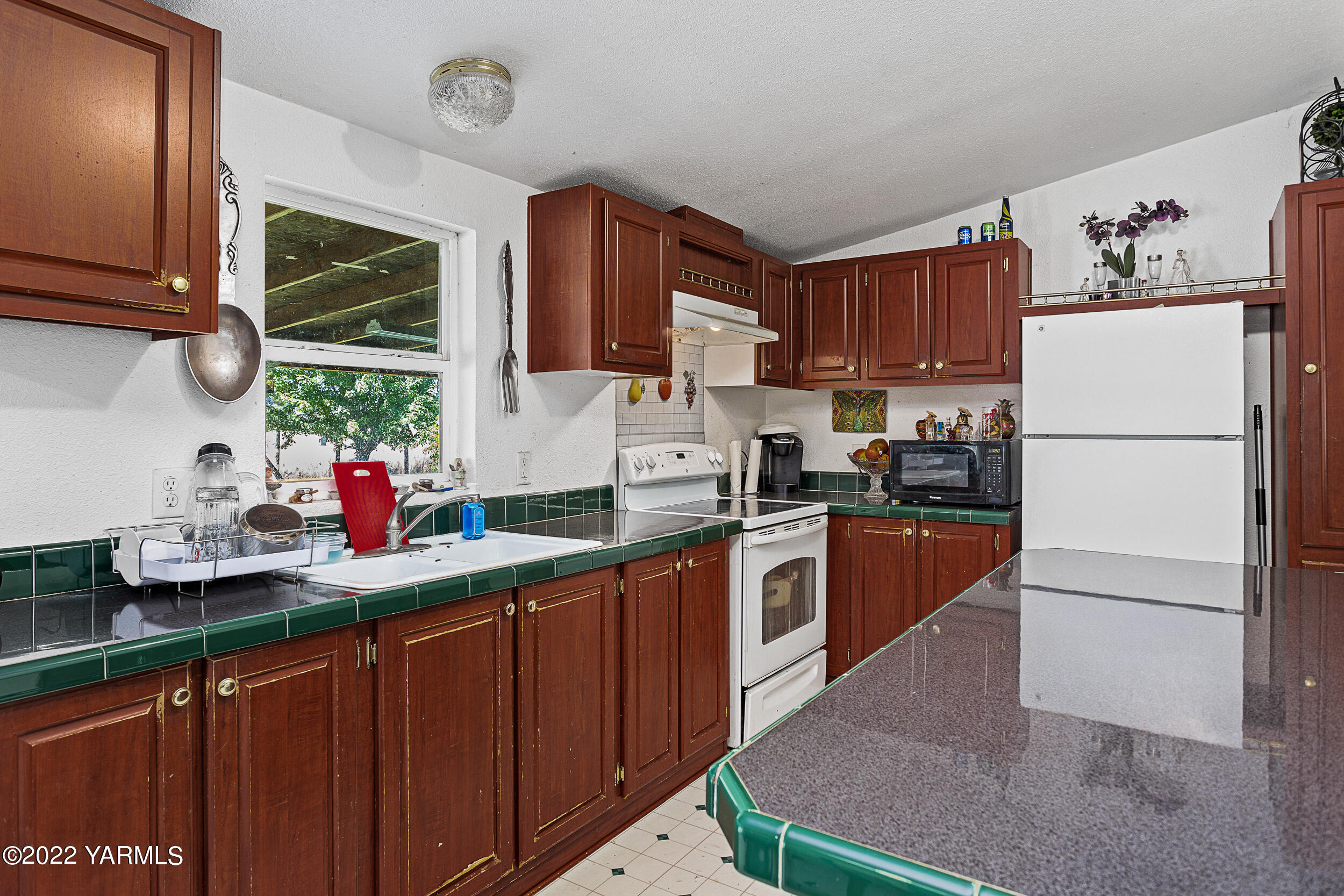 221 Rowberry Way Toppenish, WA 98948 - Photo 19 of 31 a kitchen with stainless steel appliances a sink cabinets and a window