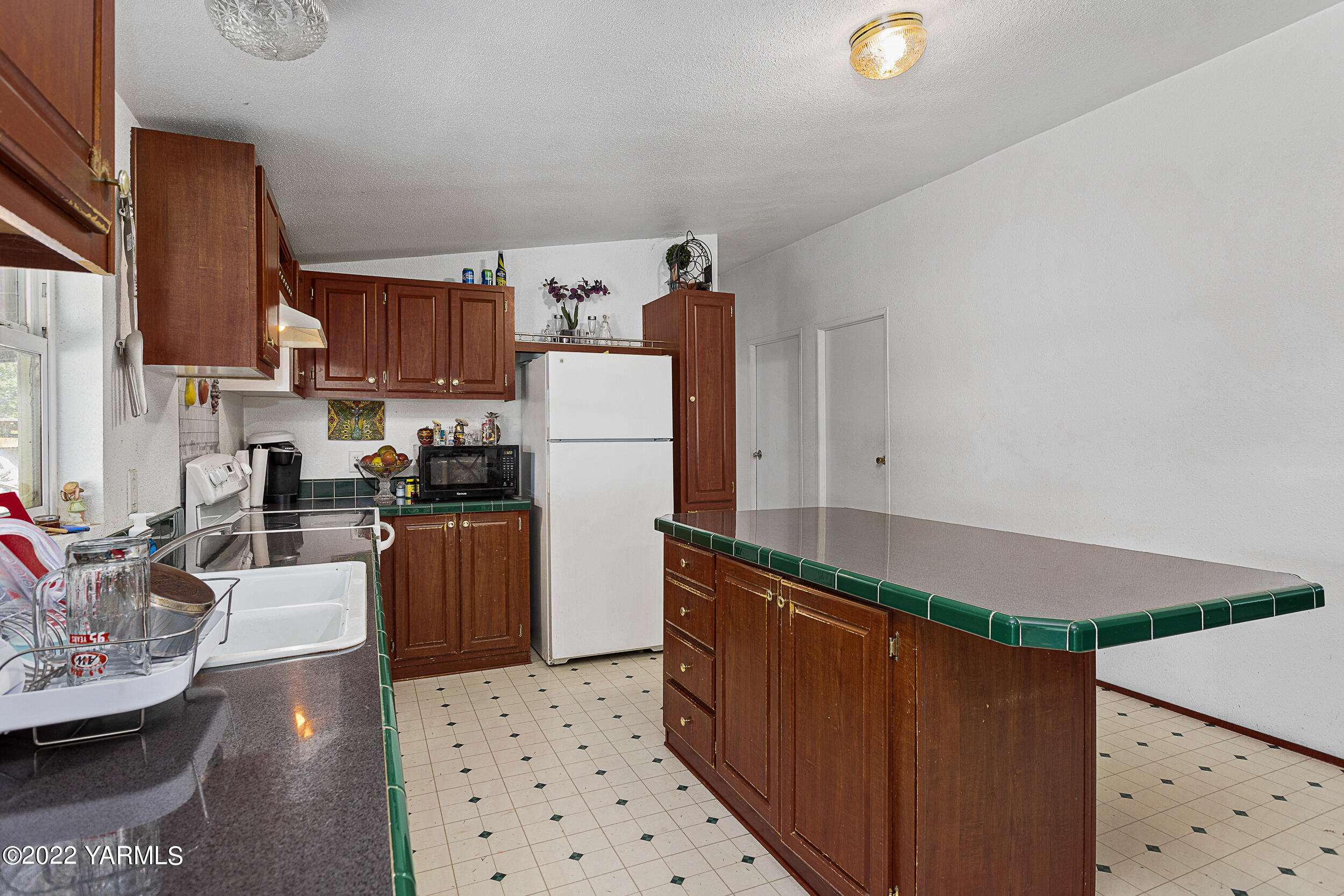 221 Rowberry Way Toppenish, WA 98948 - Photo 20 of 31 a kitchen with refrigerator and cabinets