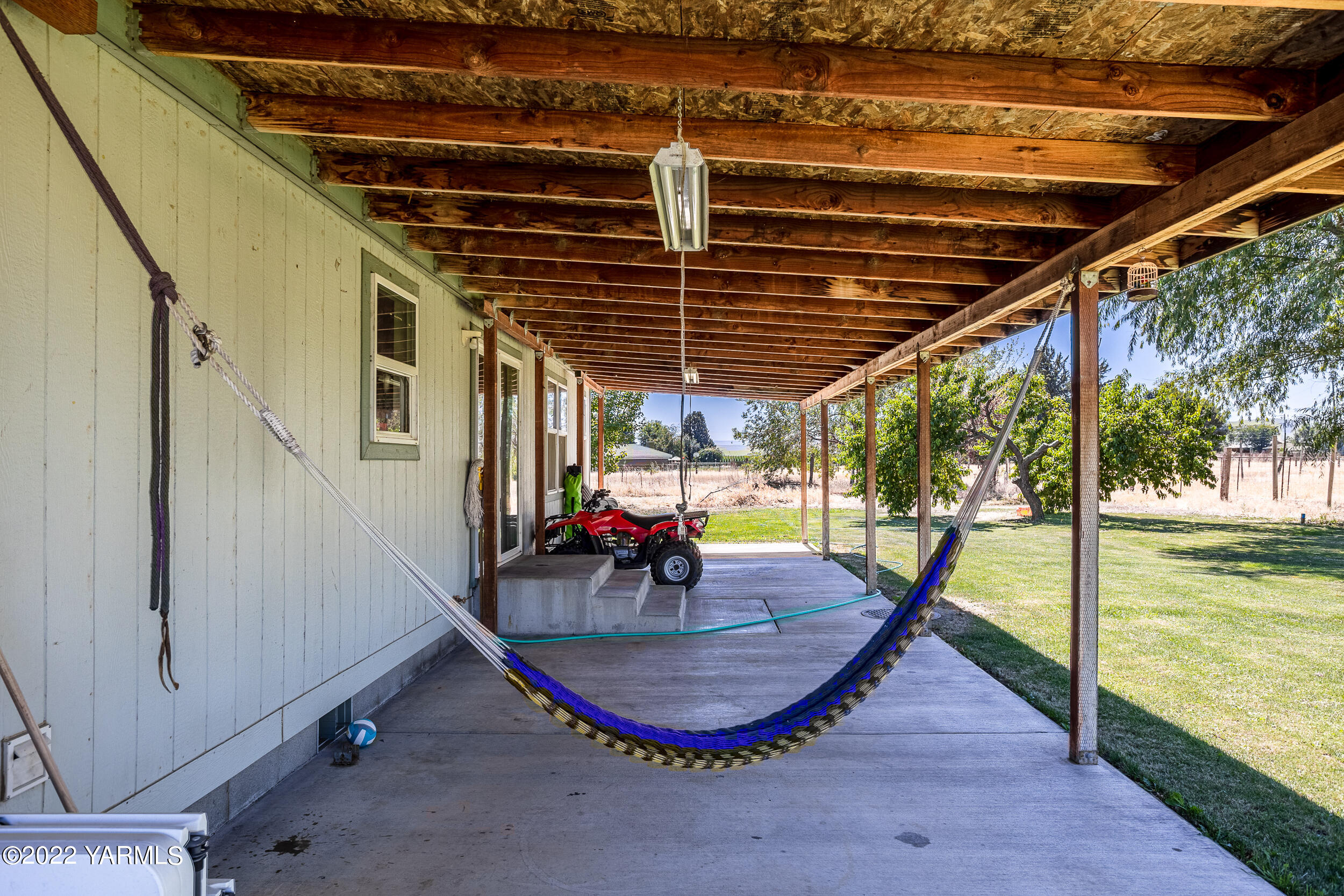 221 Rowberry Way Toppenish, WA 98948 - Photo 31 of 31 a view of a swimming pool with a patio and a yard