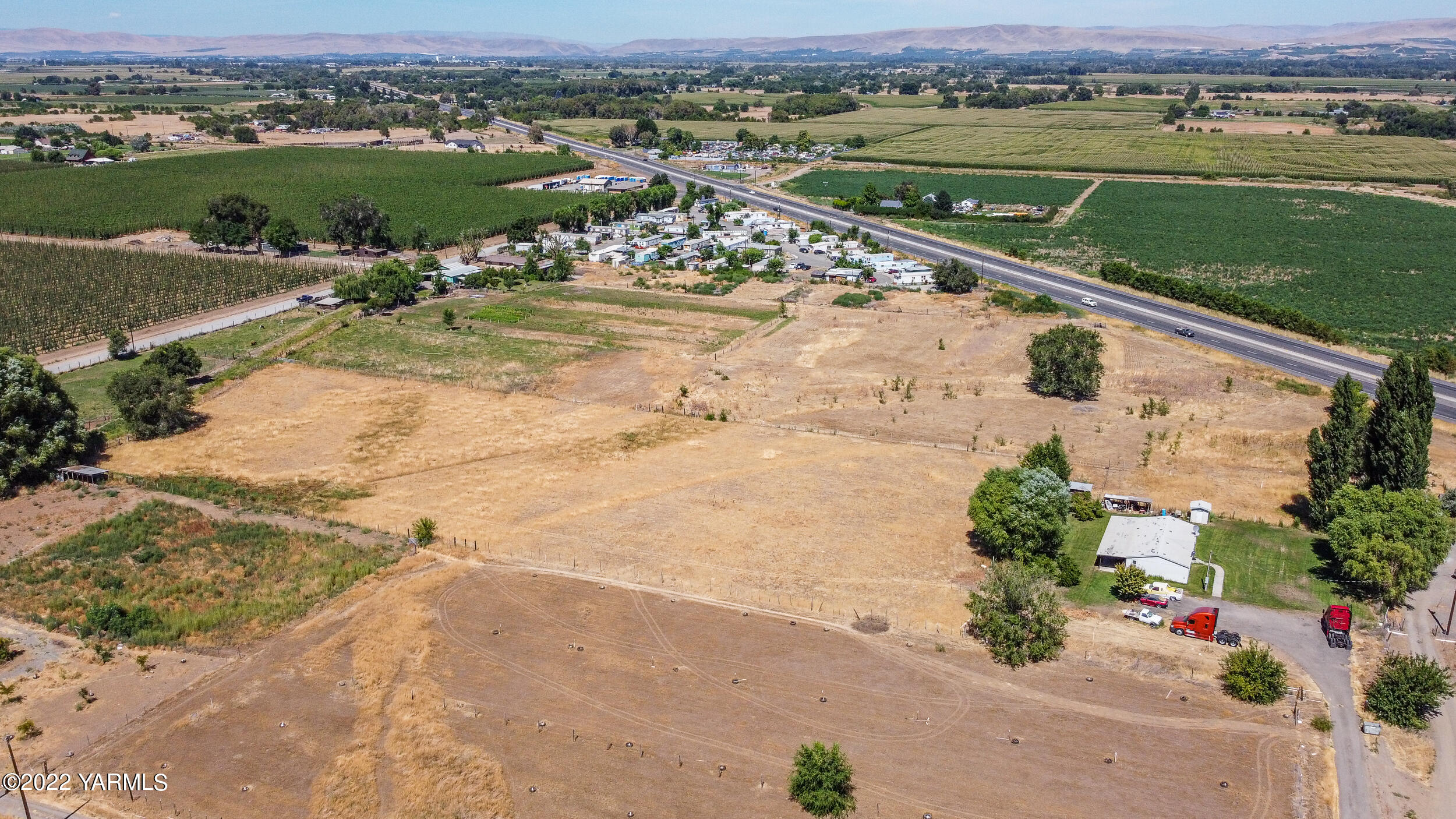 221 Rowberry Way Toppenish, WA 98948 - Photo 4 of 31 an aerial view of a house with a yard and lake view