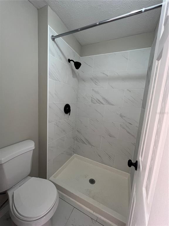 39132 County Road 54, Unit 2064 Zephyrhills, FL 33542 - Photo 11 of 20 a white toilet and shower in a bathroom