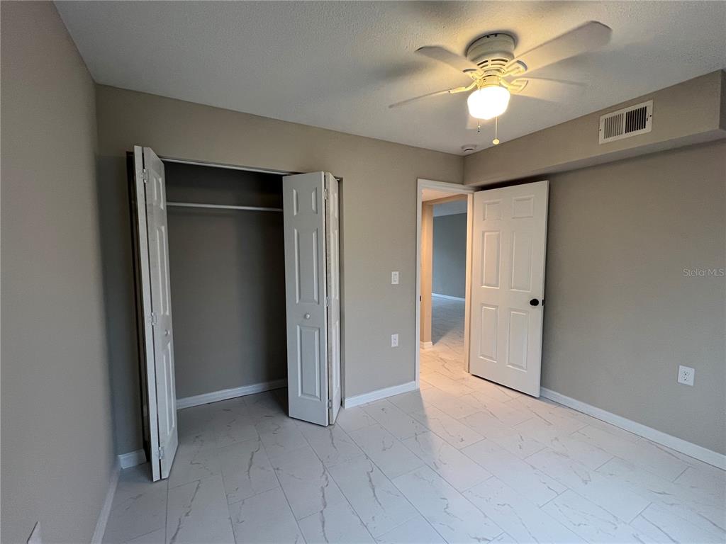 39132 County Road 54, Unit 2064 Zephyrhills, FL 33542 - Photo 13 of 20 wooden floor in an empty room with a window