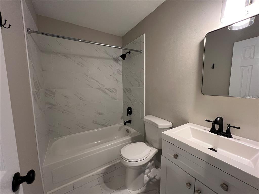39132 County Road 54, Unit 2064 Zephyrhills, FL 33542 - Photo 14 of 20 a bathroom with a sink a toilet and a bathtub