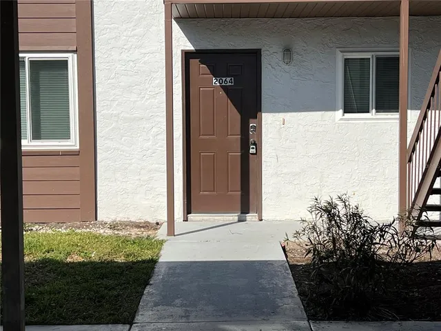 a kitchen with white cabinets stainless steel appliances and a sink