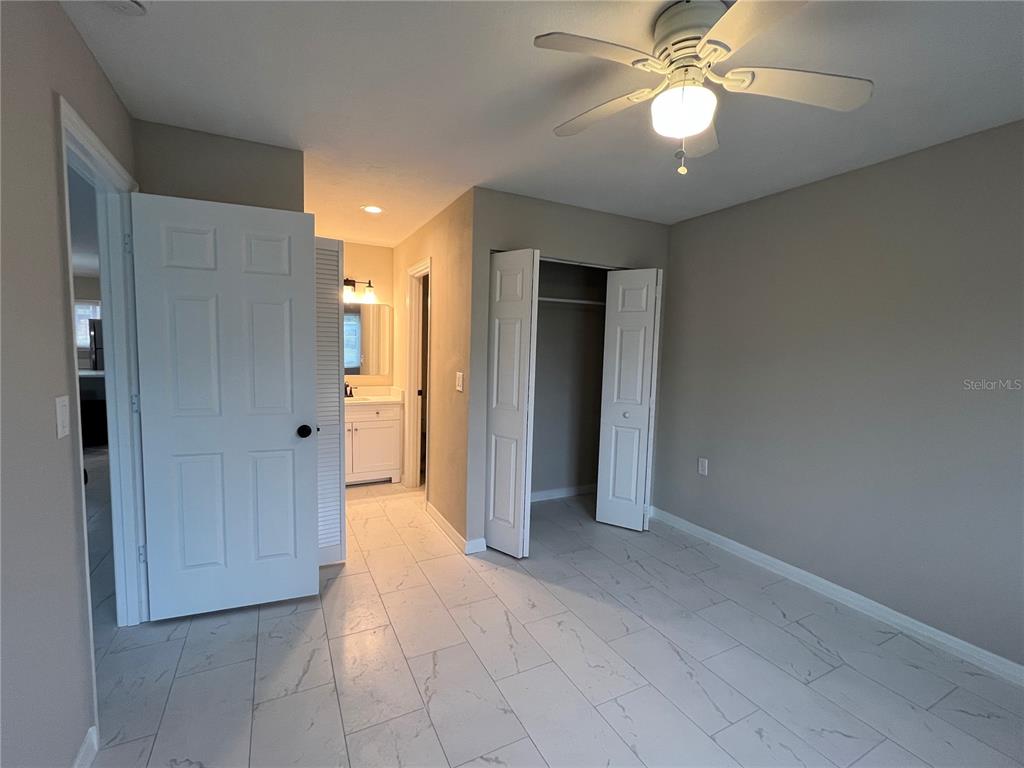 39132 County Road 54, Unit 2064 Zephyrhills, FL 33542 - Photo 9 of 20 an empty room with closet and a chandelier fan