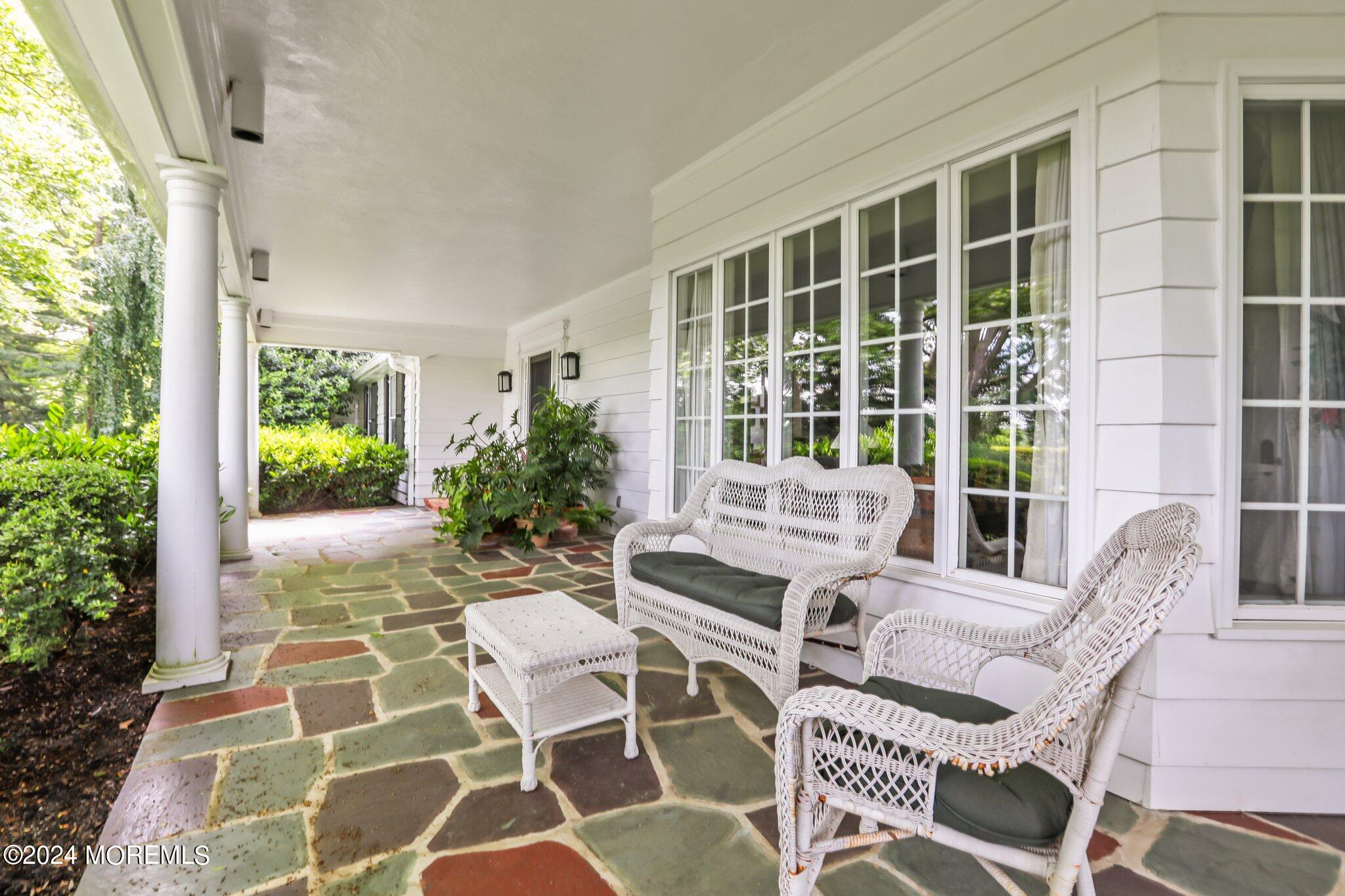 154 Rumson Road Rumson, NJ 07760 - Photo 9 of 38 a view of a patio with a chairs and table in a patio