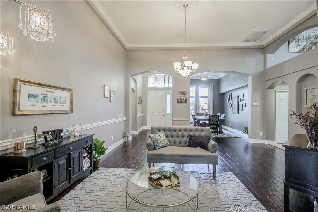 4842 Walnut Ridge Road Land O' Lakes, FL 34638 - Photo 3 of 20 a living room with fireplace furniture and a chandelier