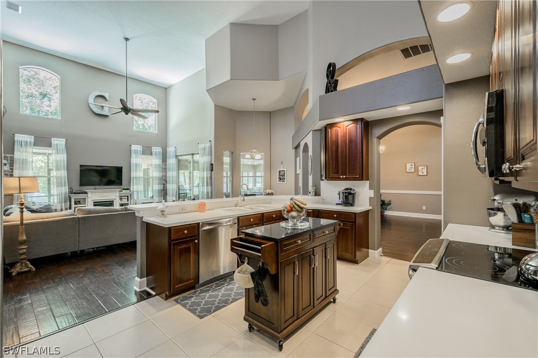 4842 Walnut Ridge Road Land O' Lakes, FL 34638 - Photo 6 of 20 a kitchen with a sink counter top space and stainless steel appliances