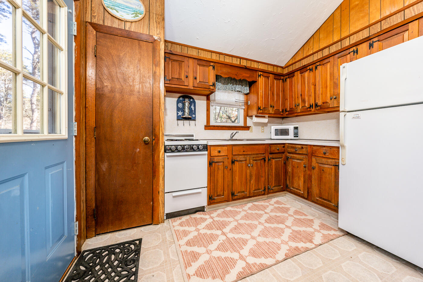 60 Long Avenue, Unit E Wellfleet, MA 02667 - Photo 3 of 22 a kitchen with stainless steel appliances granite countertop a stove a sink and a refrigerator