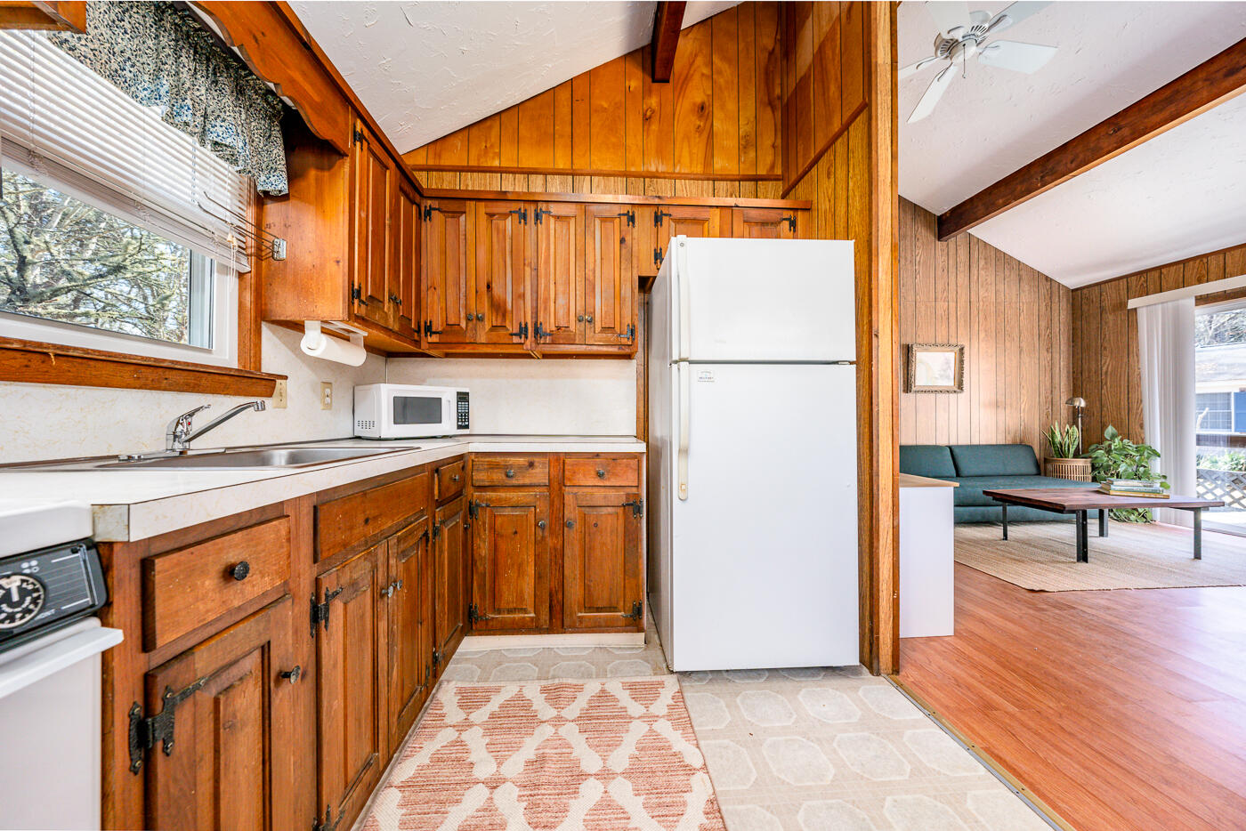 60 Long Avenue, Unit E Wellfleet, MA 02667 - Photo 5 of 22 a view of a kitchen with a sink and a refrigerator